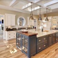 Custom kitchen renovation with large island, wood countertop, and stainless steel appliances by i BUILD KC in Kansas City
