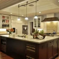 Contemporary white kitchen with island, pendant lighting, and built-in appliances.