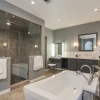 Custom bathroom renovation with walk-in shower, soaking tub, and premium tile work by i BUILD KC